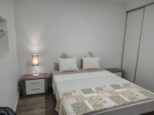 a bedroom with a bed with a quilt on it at Apartment in Semeador 1 in Portalegre