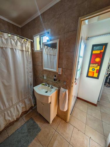 a bathroom with a sink and a shower at Depto AC Olavarria in Olavarría