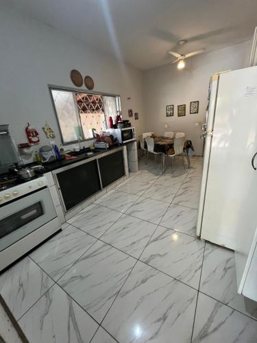 a kitchen with a refrigerator and a table at Suite in Catanduva