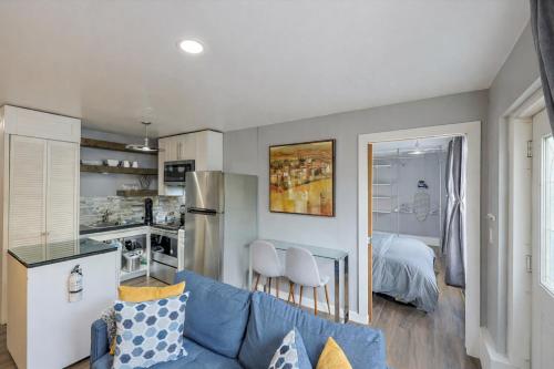 a living room with a blue couch and a kitchen at Stylish and Pet-Friendly Apartment in Beacon in Beacon