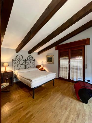 a bedroom with a large bed and a wooden floor at Passeggiata al sole in Santa Maria Maggiore