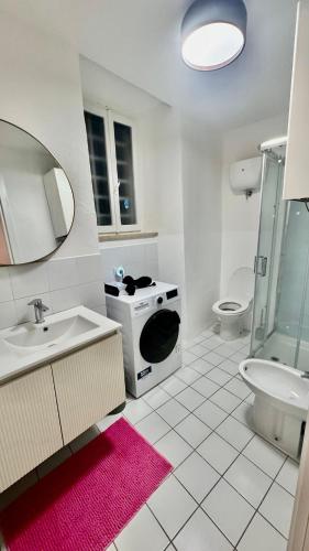 a white bathroom with a sink and a toilet at Pink House - InBorgo in Acquasparta