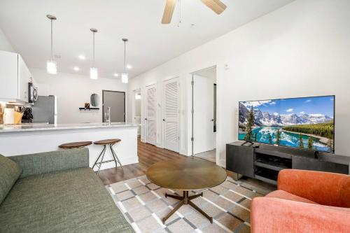 a living room with a couch and a tv at Modern 1B1B Apartment with Private Balcony - 7 in Atlanta