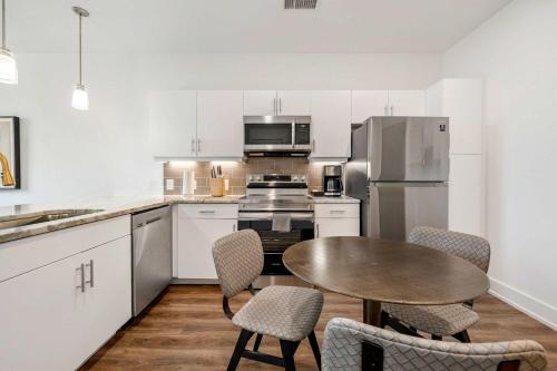 a kitchen with a table and chairs and a refrigerator at Modern 1B1B Apartment with Private Balcony - 7 in Atlanta