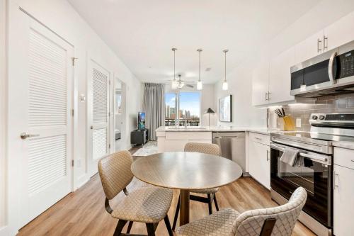 a kitchen with a table and chairs in a room at Modern 1B1B Apartment with Private Balcony - 7 in Atlanta