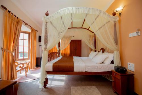 a bedroom with a bed with a canopy at Ard Lui Residence in Nuwara Eliya