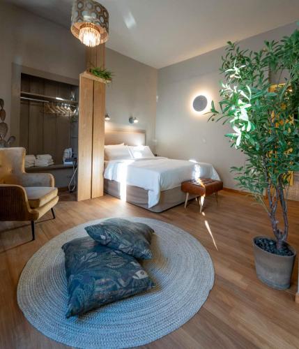 a bedroom with a large bed and a large rug at The Urban Parrot Maisonette in Ermoupoli