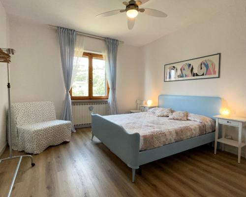 a bedroom with a bed and a chair and a window at Home Nature and Relax in Monte del Lago