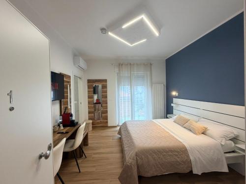 a bedroom with a bed and a desk and a sink at Palazzo del Toro 2 in Montesilvano