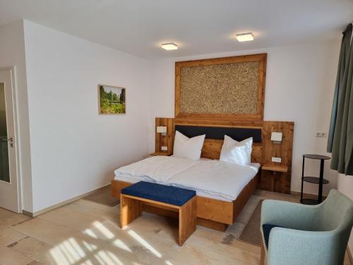 a bedroom with a bed and a blue chair at Appartement 1 mit Terrasse in Wehlenberg