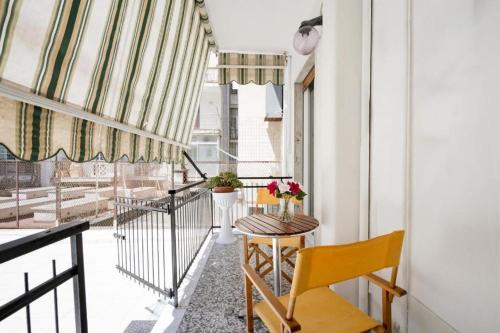 a balcony with a table and chairs and a window at AuGuStea - Modern Central Suites in Bari