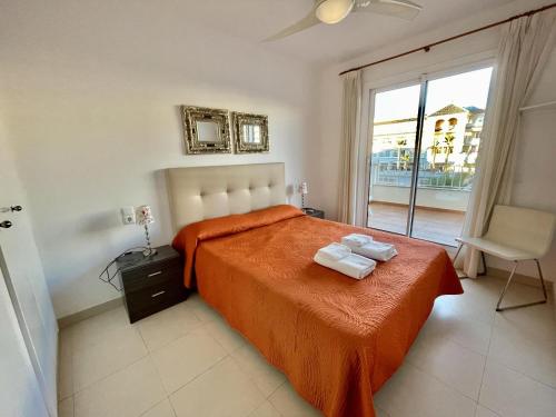 a bedroom with a bed with two towels on it at Plaza España - Central 3 Bedroom apartment - LUAL in Nerja