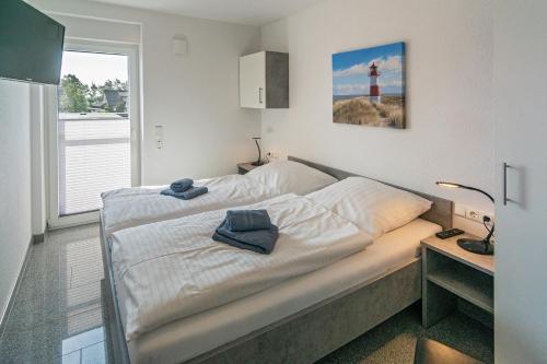 a bed in a small room with a lighthouse at Ferienhaus Bellevue in Bensersiel