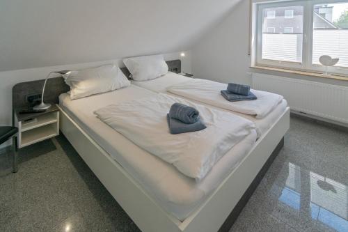 a large bed with two hats on top of it at Ferienwohnung Bel Air in Bensersiel