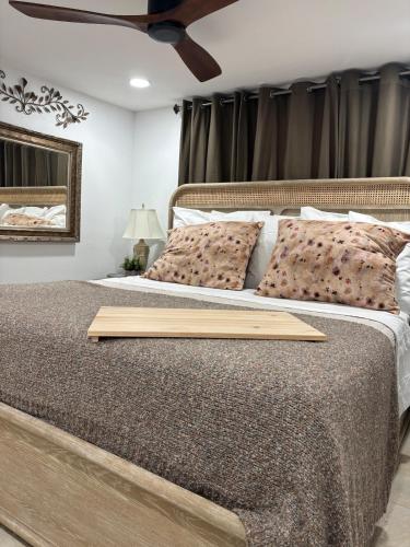a bedroom with a bed with a wooden tray on it at LasPalmas Beach Rentals,3 in Bradenton Beach