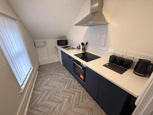 a kitchen with a sink and a counter top at The Loft Ashley Road in Poole