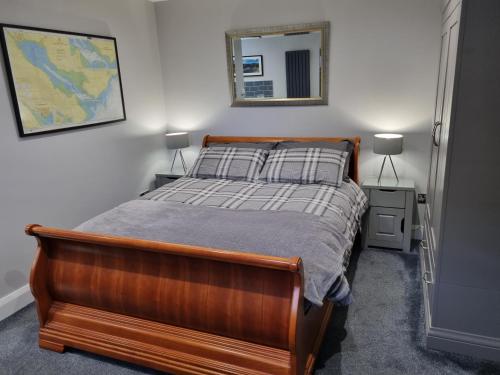 a bedroom with a bed and a mirror on the wall at The Nook in Rostrevor