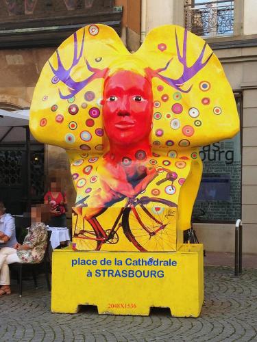 a large painting of a person on a sign at La Cour des Amis in Vendenheim
