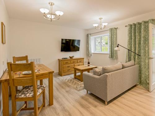 a living room with a couch and a table at Foxwhelp in Ledbury