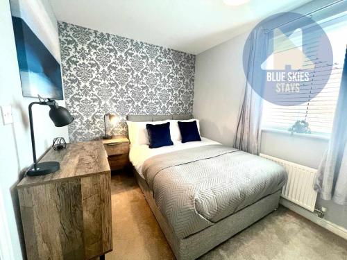 a small bedroom with a bed and a window at Puffin House in Seaton Carew