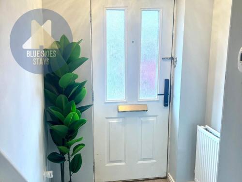 a white door with a plant next to it at Puffin House in Seaton Carew