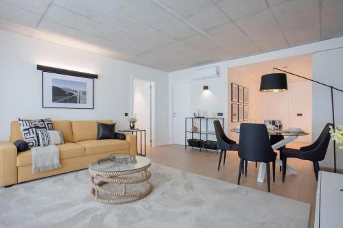 a living room with a couch and a table at Liiiving in Gaia - Beach Seaside Apartment in Vila Nova de Gaia