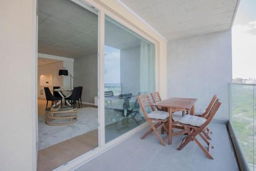 a dining room with a table and chairs on a balcony at Liiiving in Gaia - Beach Seaside Apartment in Vila Nova de Gaia
