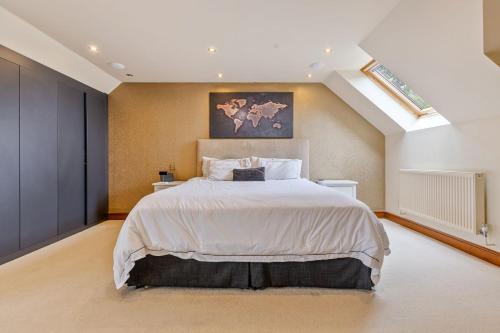 a bedroom with a large bed and a skylight at Broadridge Manor in West Worlington