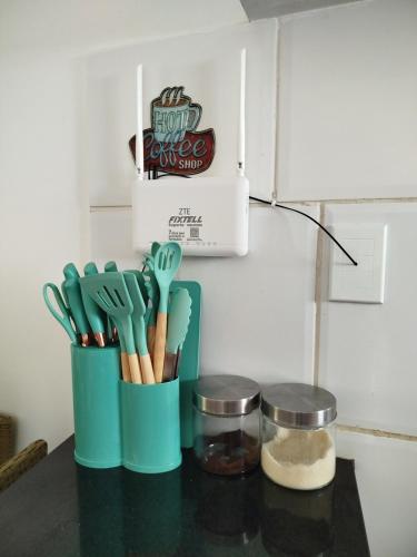 a cup of utensils sitting on a counter top at Mar à vista in São Luís