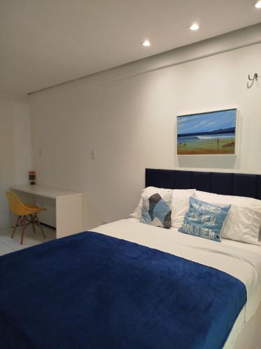a bedroom with a bed with a blue blanket at Mar à vista in São Luís