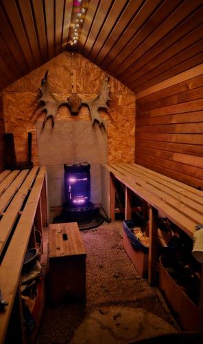 a room with two benches and a tv in a sauna at Björklunda, lakes, canoe, sauna in Näfstorp