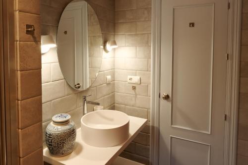 a bathroom with a white sink and a mirror at Casa del Bienestar in Lanjarón