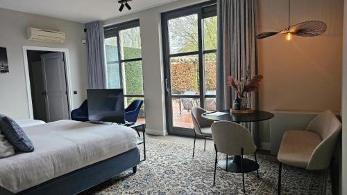 a bedroom with a bed and a table and chairs at Guest Room Utrecht in Utrecht