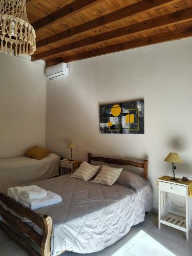 a bedroom with a bed in a room with wooden ceilings at Los jazmines de Duggan in Duggan