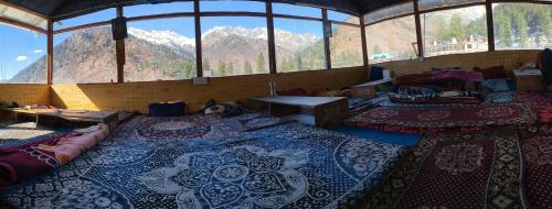 a room with a view of a room with mountains at Peace homestay n cafe in Kalgha