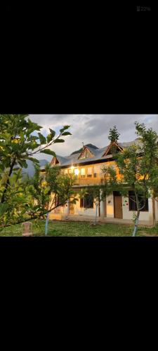 a large building with trees in front of it at Peace homestay n cafe in Kalgha