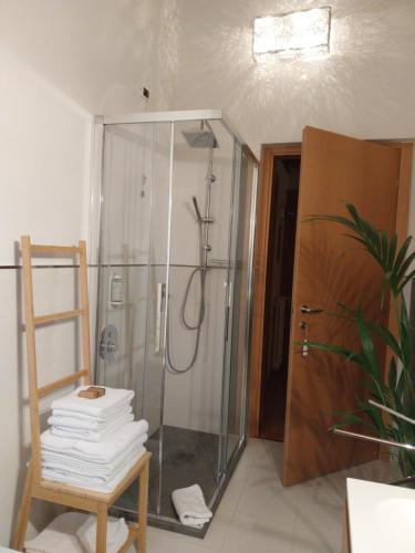 a shower with a glass door in a bathroom at B&B AI PELLEGRINI in Villa Santina