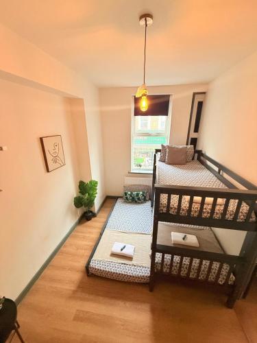 a room with two bunk beds and a window at Kilburn Guest Rooms 167 in London