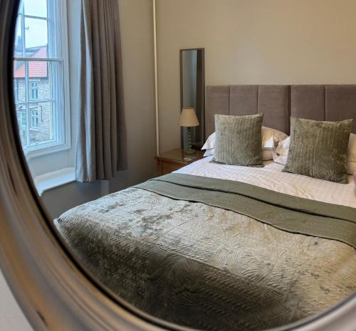 a bedroom with a large bed and a window at Bramwood Guest House in Pickering