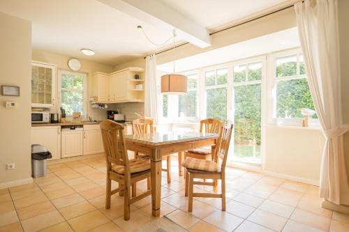 a kitchen with a wooden table and chairs at Ferienhaus Werder in Zingst in Zingst
