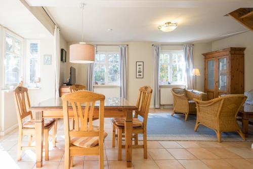 a dining room and living room with a table and chairs at Ferienhaus Werder in Zingst in Zingst