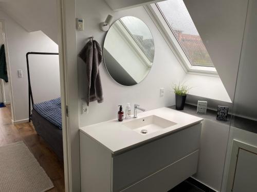a bathroom with a sink and a mirror at An apartment overlooking the harbor Kolding fjord in Kolding