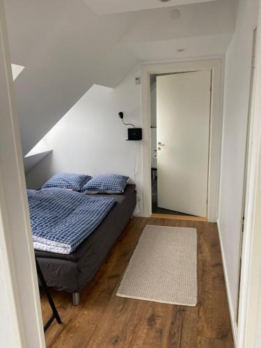 a bedroom with a bed and a white door at An apartment overlooking the harbor Kolding fjord in Kolding