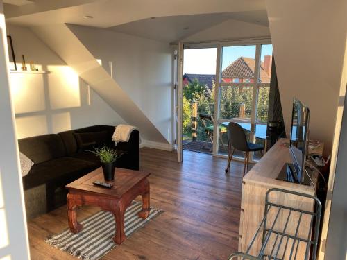 a living room with a couch and a table at An apartment overlooking the harbor Kolding fjord in Kolding