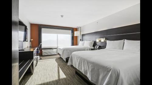 a hotel room with two beds and a television at Holiday Inn Express & Suites - Bensenville - O'Hare by IHG in Bensenville