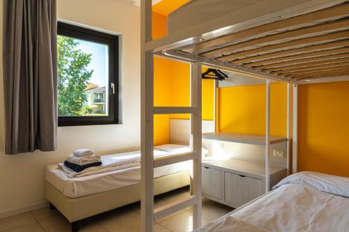 a bedroom with two bunk beds and a window at Belvedere Village in Castelnuovo del Garda