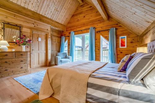 a bedroom with a bed in a wooden cabin at 3 Bed in Wadebridge oc-p34722 in Little Petherick