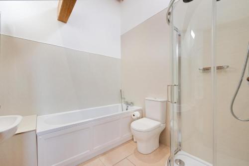 a white bathroom with a toilet and a shower at 2 Bed in Tenterden oc-tn607 in Stone