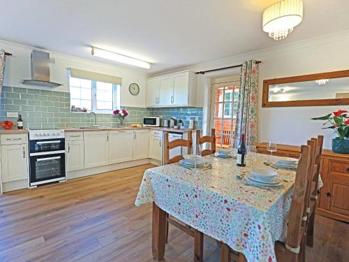 a kitchen with a table with a table cloth at Tom Putt in Ledbury