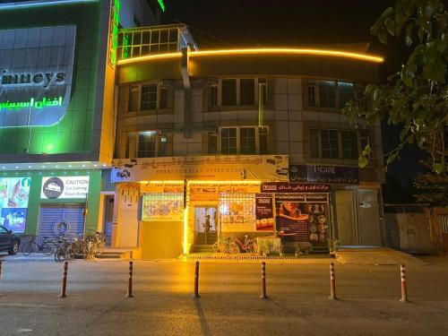 a building with lights in front of it at night at Star Shirpoor Guest House in Kabul